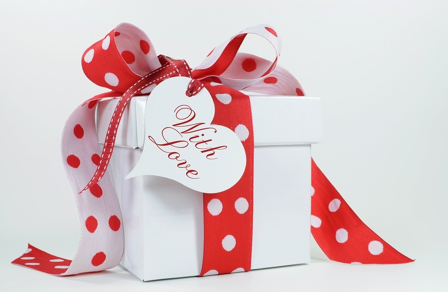 Red and white polka dot theme gift box present with heart shape gift tag with love image.