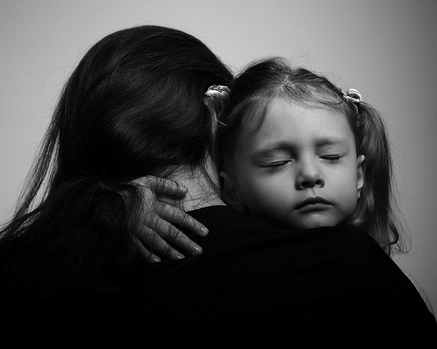 daughter hugging her mother with sad face. Closeup portrait black and white