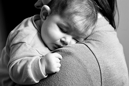 Little Baby girl sleeping in mothers arms - Lifestyle black and